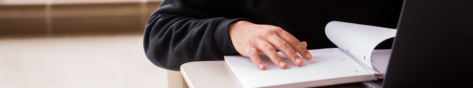 student studying at table with book