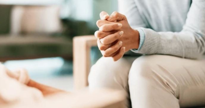 person with clasped hands